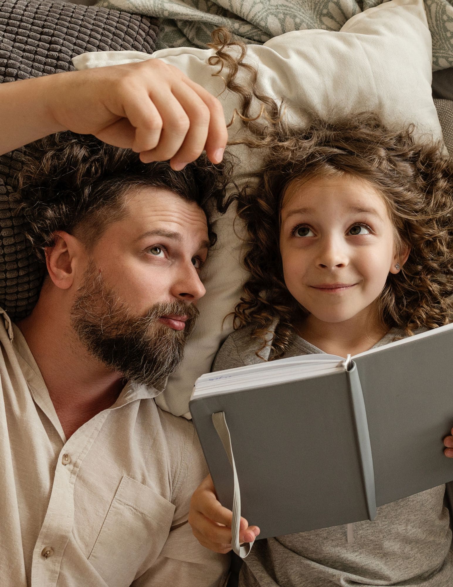 dad and daughter reading in bed dad and daughter reading in bed